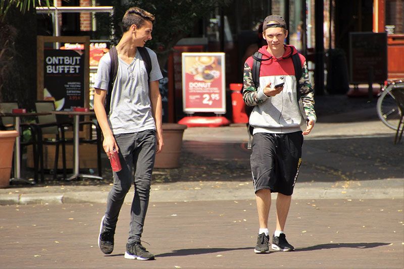 teenagers crossing street