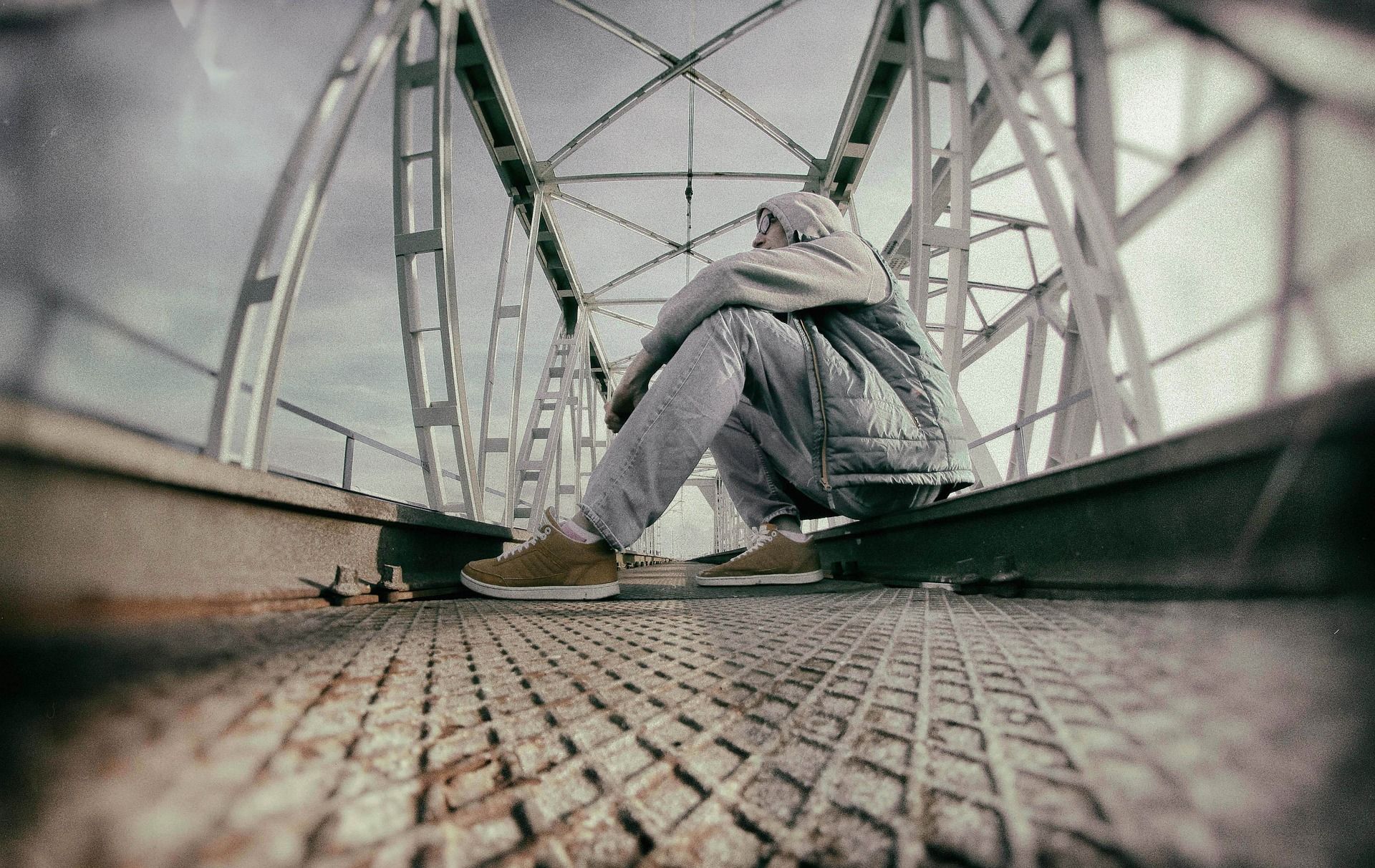 child sitting on bridge