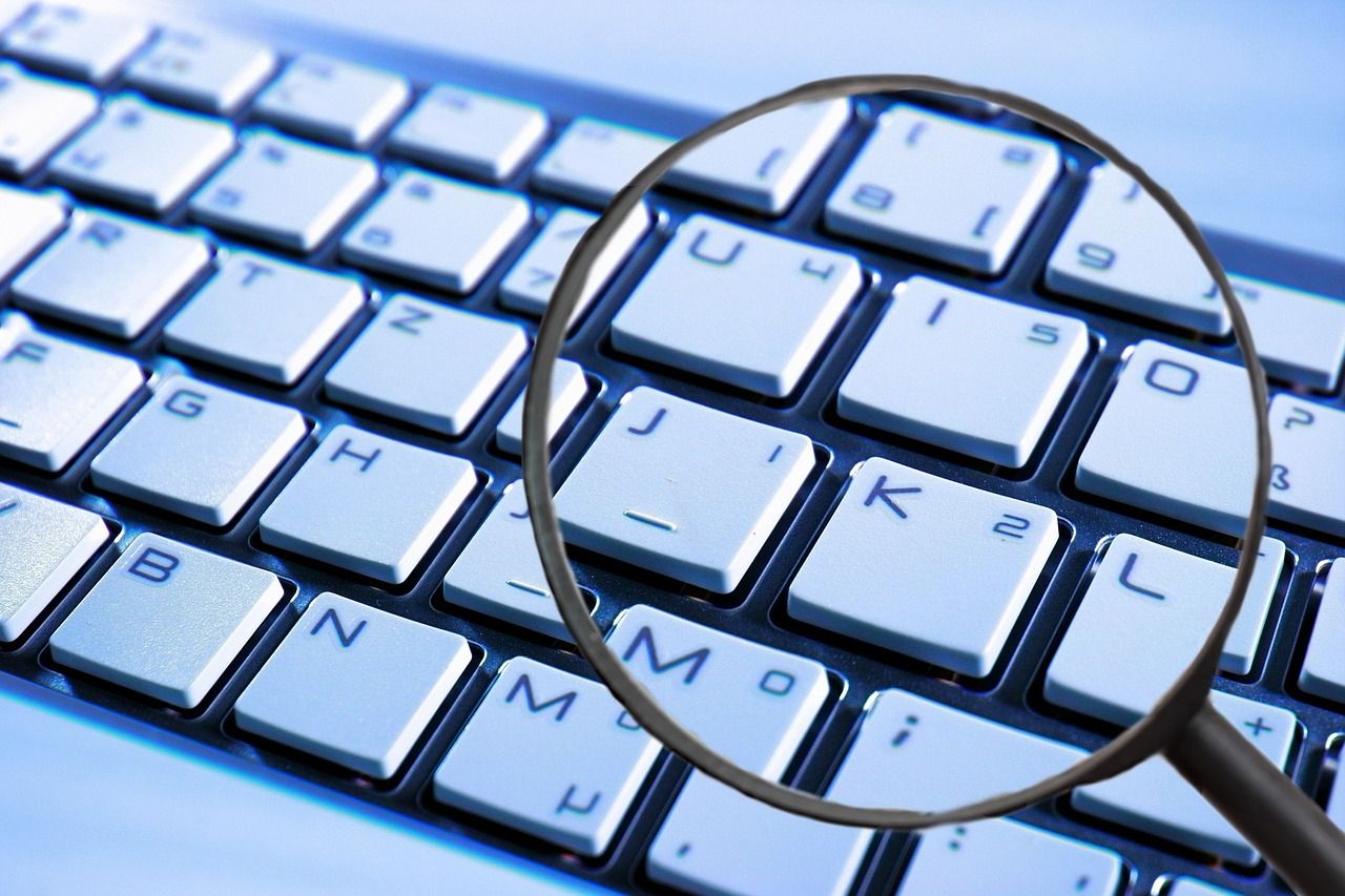 magnifying glass and keyboard