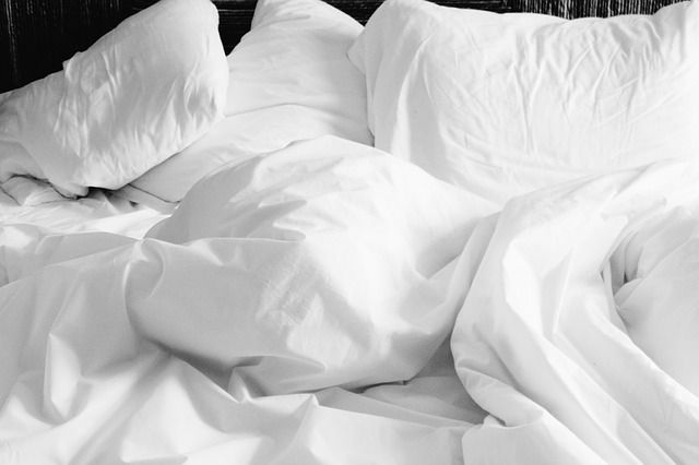 white pillow and covers
